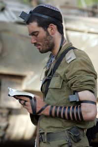 IDF soldier praying with tefillin